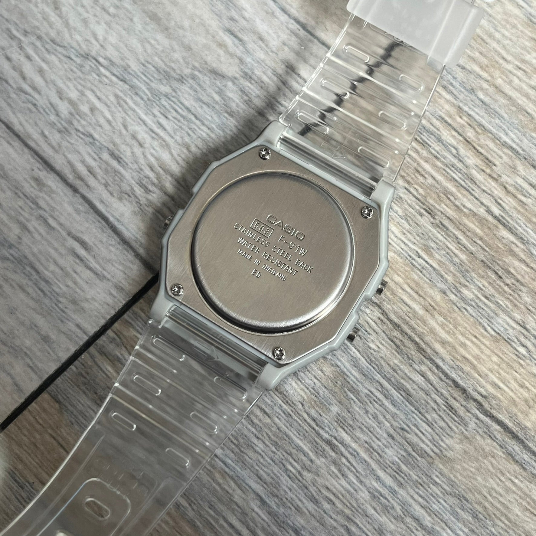 Custom Casio F-91W Clear/Transparent digital watch featuring a see through/clear filter screen. Slim 8.5 mm profile, lightweight 21 g build and flexible bio-based resin band ensure lasting comfort. Includes alarm, stopwatch, and microlight function for everyday functionality.