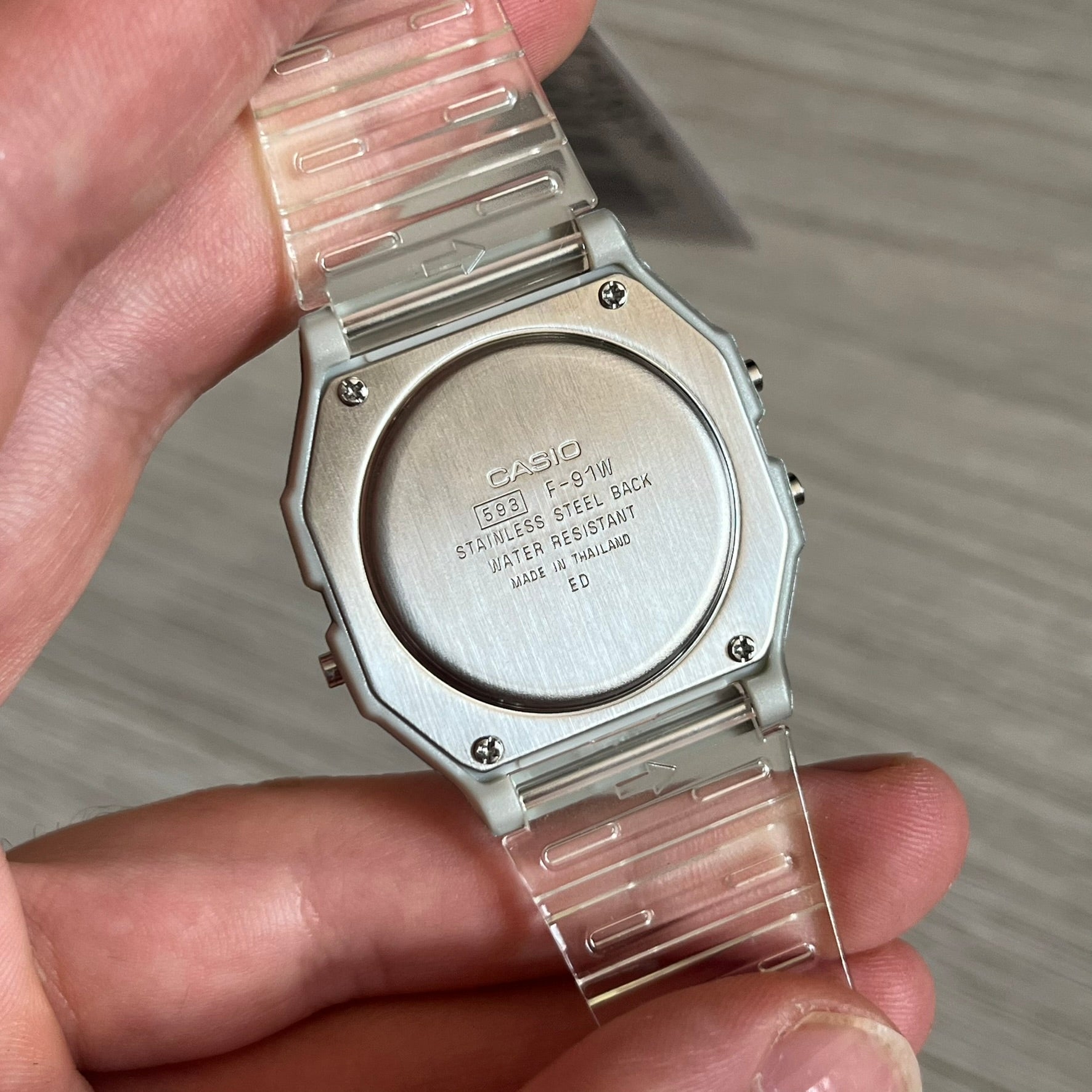 Custom Casio F-91W Clear/Transparent digital watch featuring a Spanish Flag filter screen. Slim 8.5 mm profile, lightweight 21 g build and flexible bio-based resin band ensure lasting comfort. Includes alarm, stopwatch, and microlight function for everyday functionality.