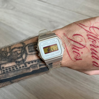 Custom Casio F-91W Clear/Transparent digital watch featuring a Spanish Flag filter screen. Slim 8.5 mm profile, lightweight 21 g build and flexible bio-based resin band ensure lasting comfort. Includes alarm, stopwatch, and microlight function for everyday functionality.