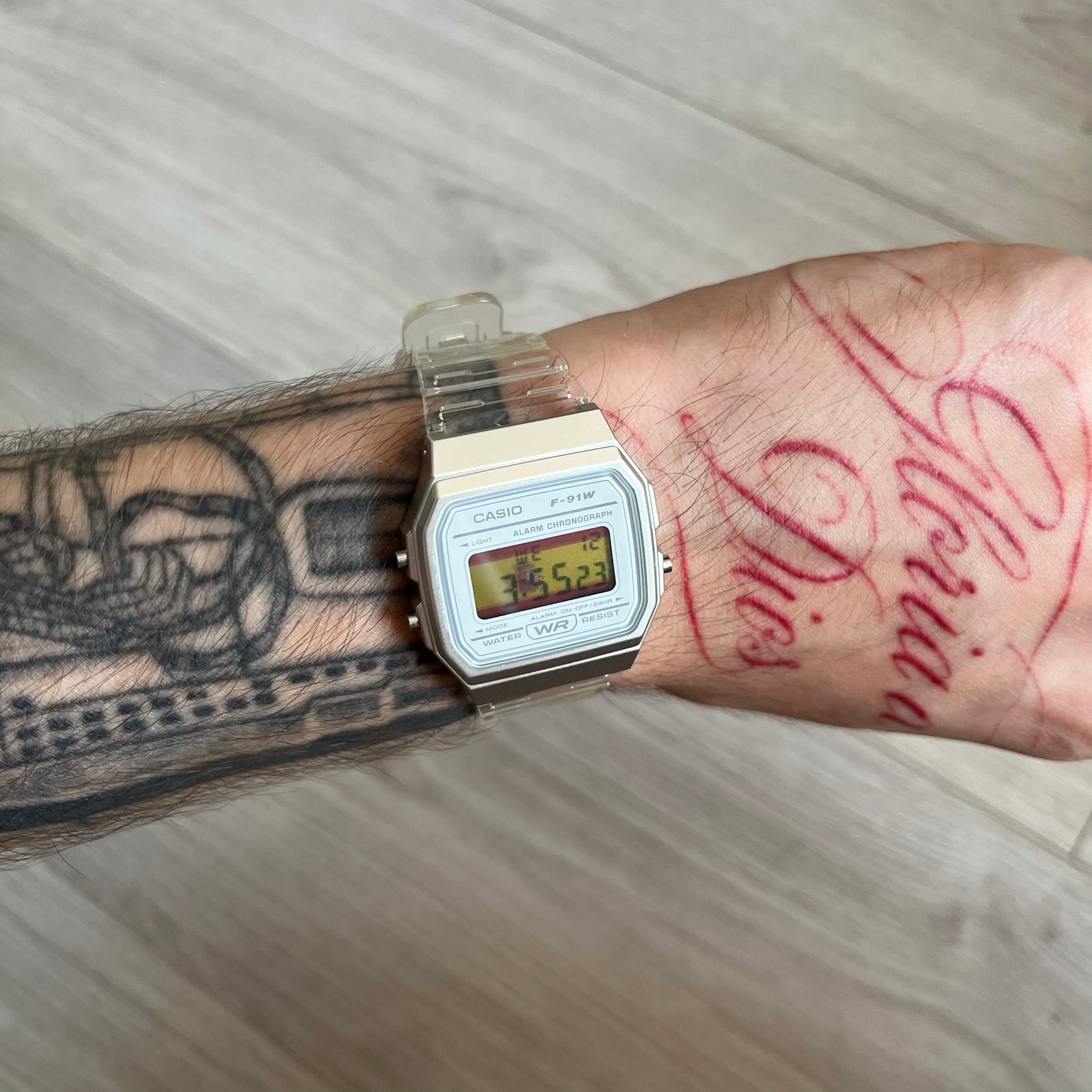 Custom Casio F-91W Clear/Transparent digital watch featuring a Spanish Flag filter screen. Slim 8.5 mm profile, lightweight 21 g build and flexible bio-based resin band ensure lasting comfort. Includes alarm, stopwatch, and microlight function for everyday functionality.