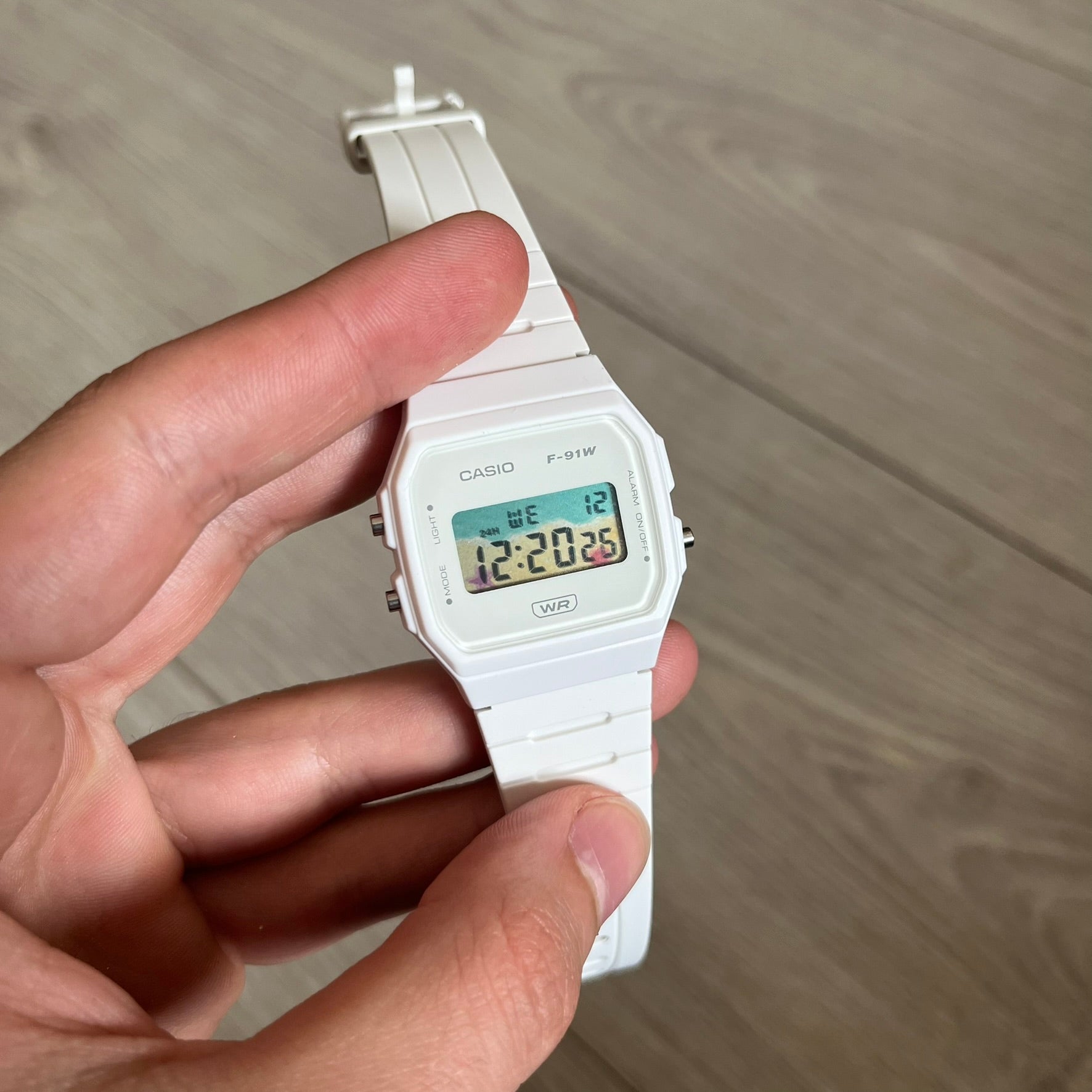 Custom Casio F-91W White digital watch featuring a Sandy beach filter screen. Slim 8.5 mm profile, lightweight 21 g build and flexible bio-based resin band ensure lasting comfort. Includes alarm, stopwatch, and microlight function for everyday functionality.