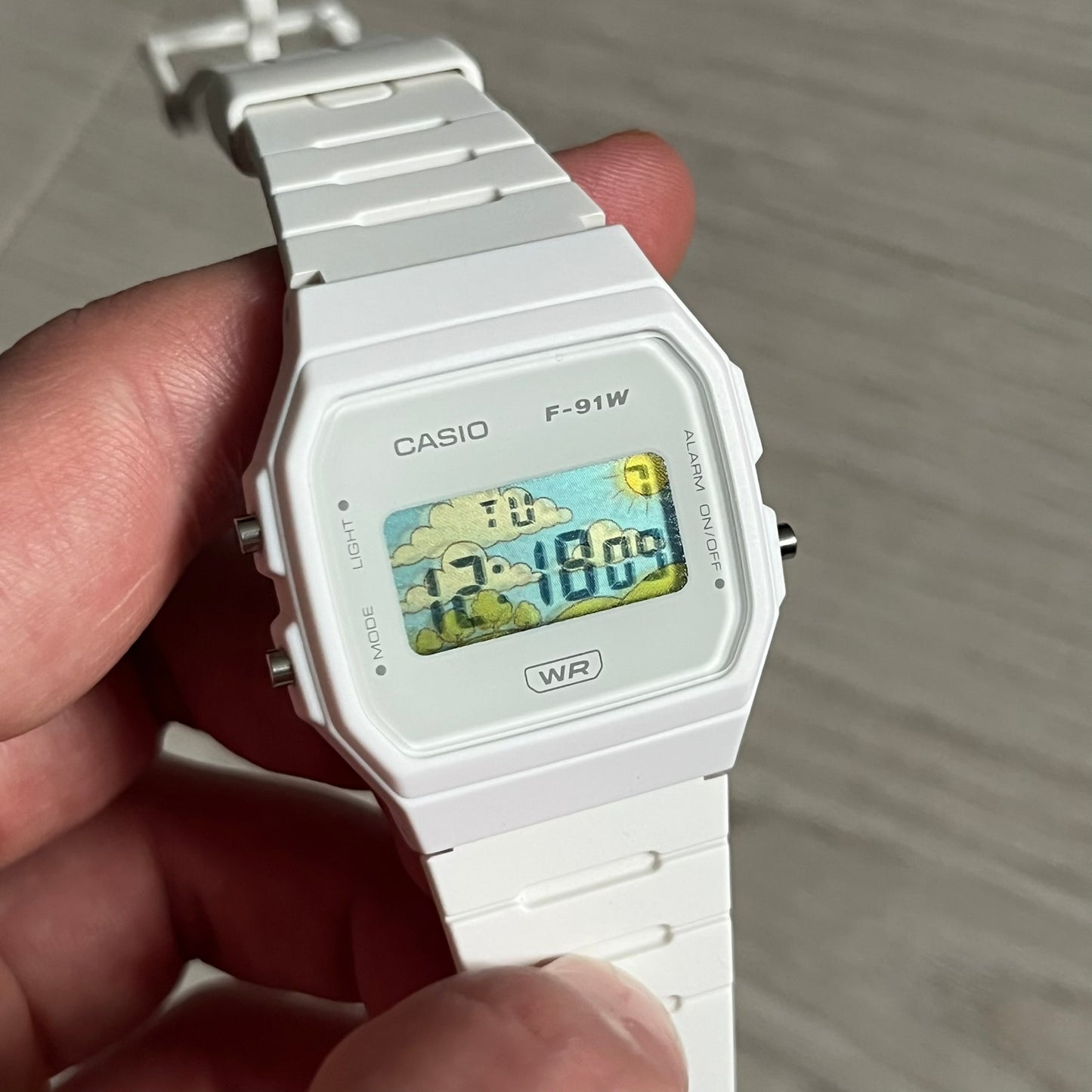 Custom Casio F-91W White digital watch featuring a Landscape filter screen. Slim 8.5 mm profile, lightweight 21 g build and flexible bio-based resin band ensure lasting comfort. Includes alarm, stopwatch, and microlight function for everyday functionality.