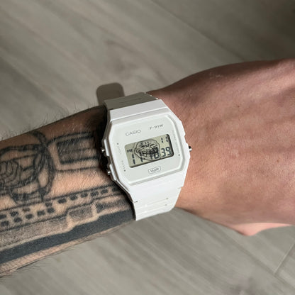Custom Casio F-91W White digital watch featuring a Trollface meme filter screen. Slim 8.5 mm profile, lightweight 21 g build and flexible bio-based resin band ensure lasting comfort. Includes alarm, stopwatch, and microlight function for everyday functionality.