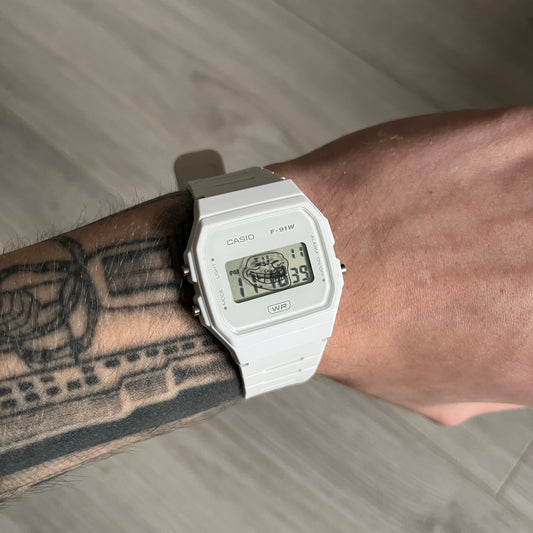 Custom Casio F-91W White digital watch featuring a Trollface meme filter screen. Slim 8.5 mm profile, lightweight 21 g build and flexible bio-based resin band ensure lasting comfort. Includes alarm, stopwatch, and microlight function for everyday functionality.