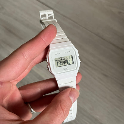 Custom Casio F-91W White digital watch featuring a Trollface meme filter screen. Slim 8.5 mm profile, lightweight 21 g build and flexible bio-based resin band ensure lasting comfort. Includes alarm, stopwatch, and microlight function for everyday functionality.