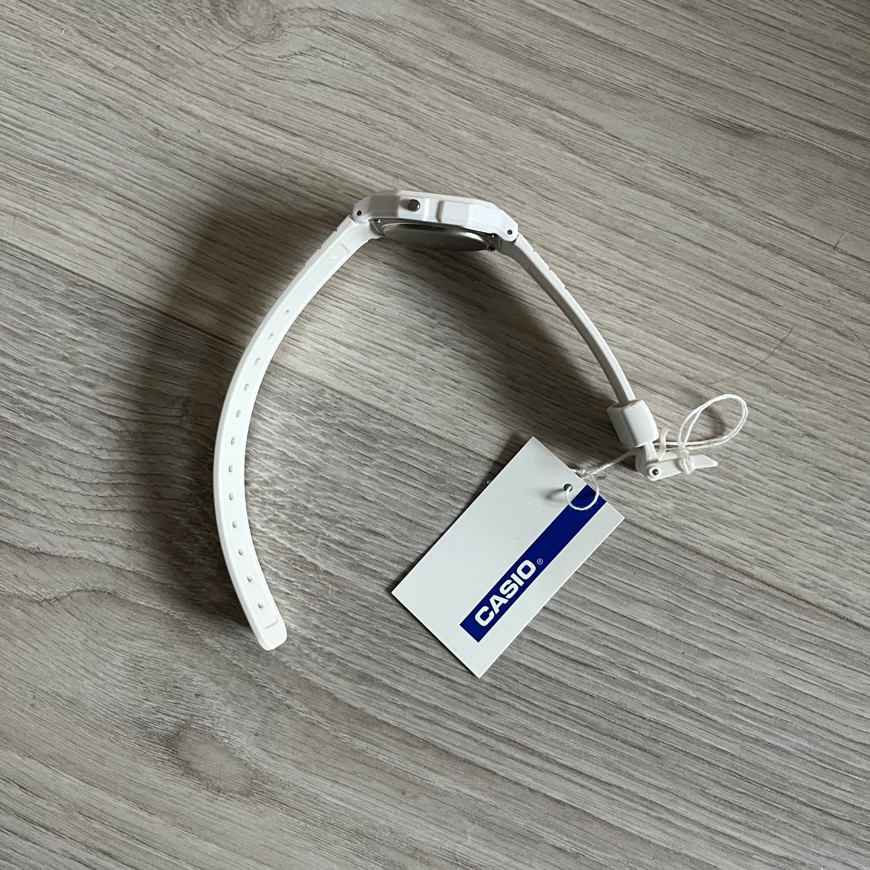 Custom Casio F-91W White digital watch featuring a Trollface meme filter screen. Slim 8.5 mm profile, lightweight 21 g build and flexible bio-based resin band ensure lasting comfort. Includes alarm, stopwatch, and microlight function for everyday functionality.