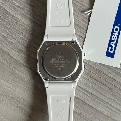 Custom Casio F-91W White digital watch featuring a Trollface meme filter screen. Slim 8.5 mm profile, lightweight 21 g build and flexible bio-based resin band ensure lasting comfort. Includes alarm, stopwatch, and microlight function for everyday functionality.
