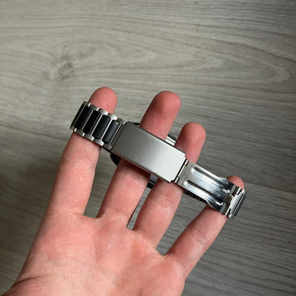 Casio Wrist Camera 2220 WQV-1 Digital Watch from the 2000s, made in Japan. Features a built-in camera module at the top, with six function buttons for photo capture, IR communication, alarm, timer, stopwatch, and gallery viewing. Monochrome photo output in shades of black, white, and gray; fitted with a non-original bracelet.