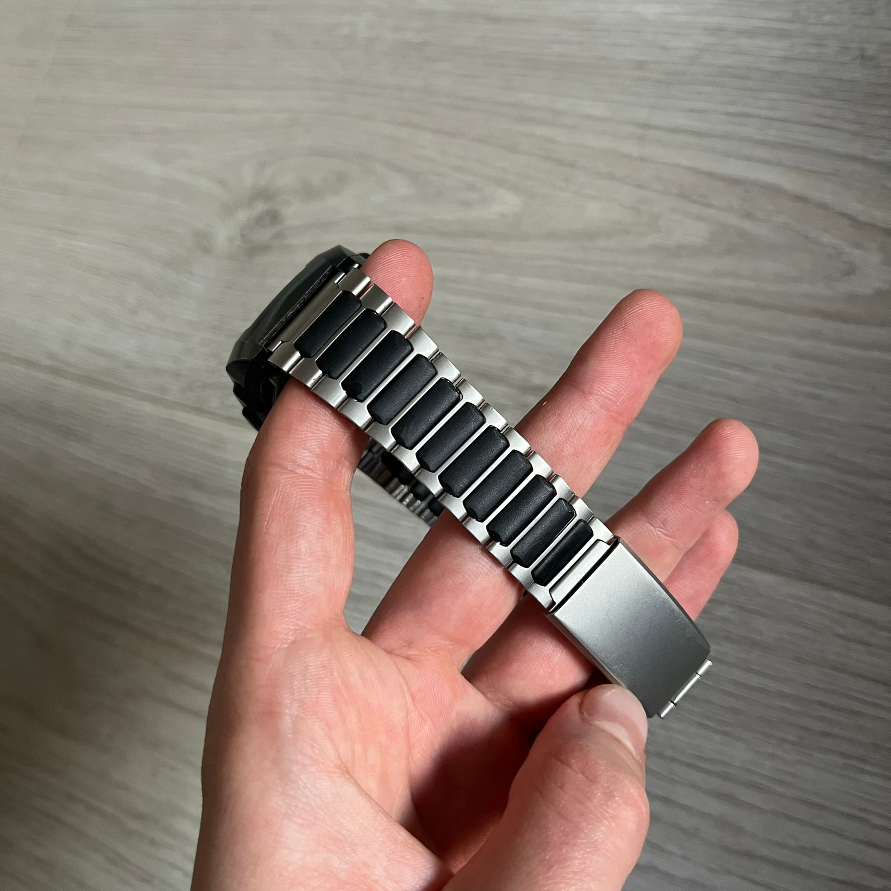 Casio Wrist Camera 2220 WQV-1 Digital Watch from the 2000s, made in Japan. Features a built-in camera module at the top, with six function buttons for photo capture, IR communication, alarm, timer, stopwatch, and gallery viewing. Monochrome photo output in shades of black, white, and gray; fitted with a non-original bracelet.