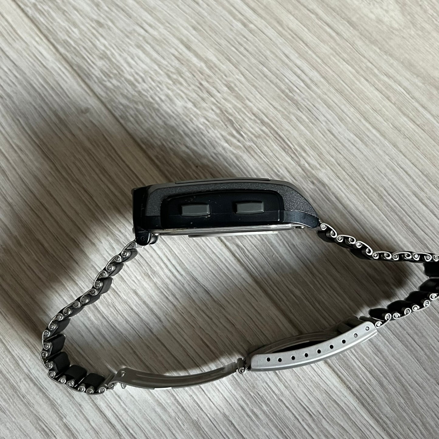 Casio Wrist Camera 2220 WQV-1 Digital Watch from the 2000s, made in Japan. Features a built-in camera module at the top, with six function buttons for photo capture, IR communication, alarm, timer, stopwatch, and gallery viewing. Monochrome photo output in shades of black, white, and gray; fitted with a non-original bracelet.