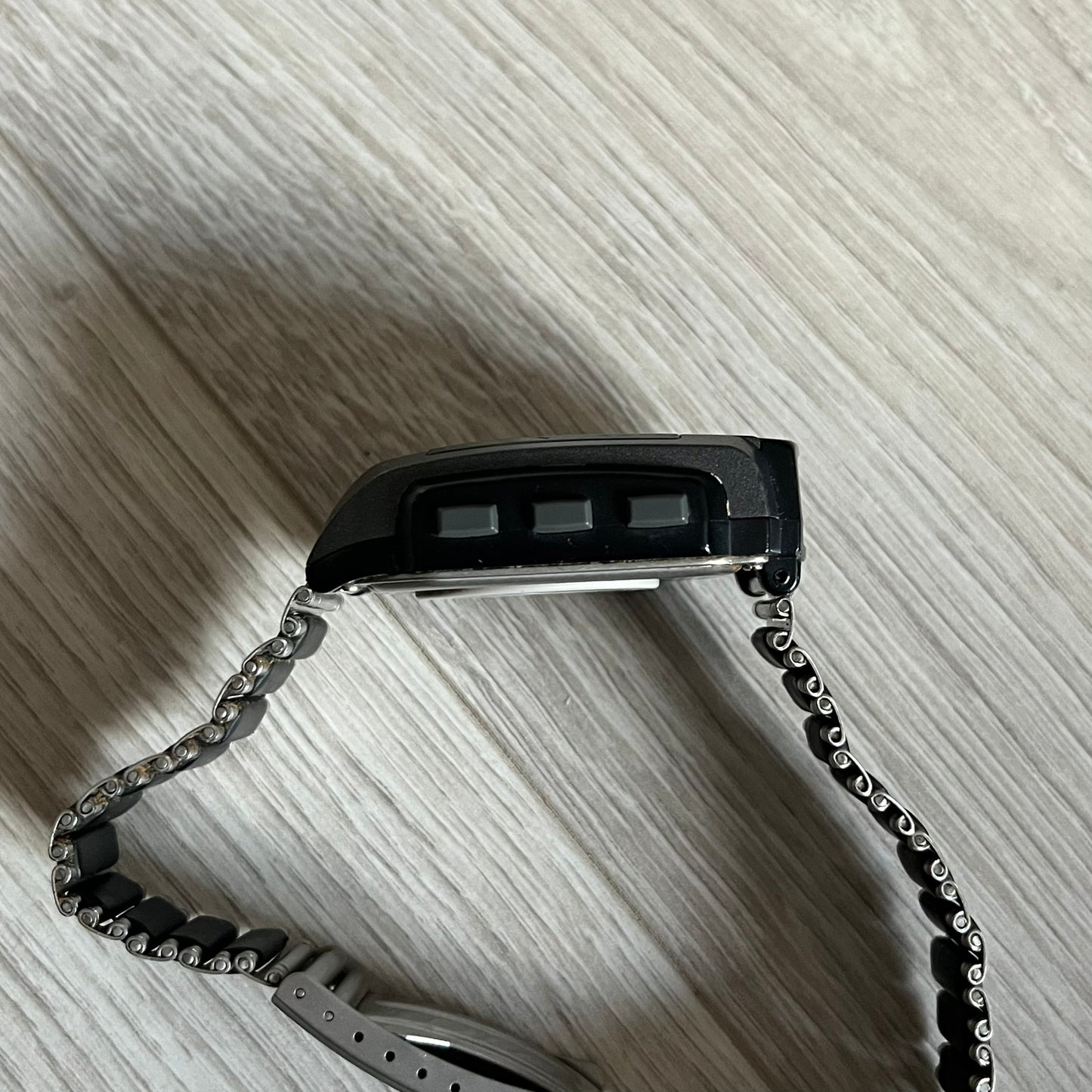 Casio Wrist Camera 2220 WQV-1 Digital Watch from the 2000s, made in Japan. Features a built-in camera module at the top, with six function buttons for photo capture, IR communication, alarm, timer, stopwatch, and gallery viewing. Monochrome photo output in shades of black, white, and gray; fitted with a non-original bracelet.