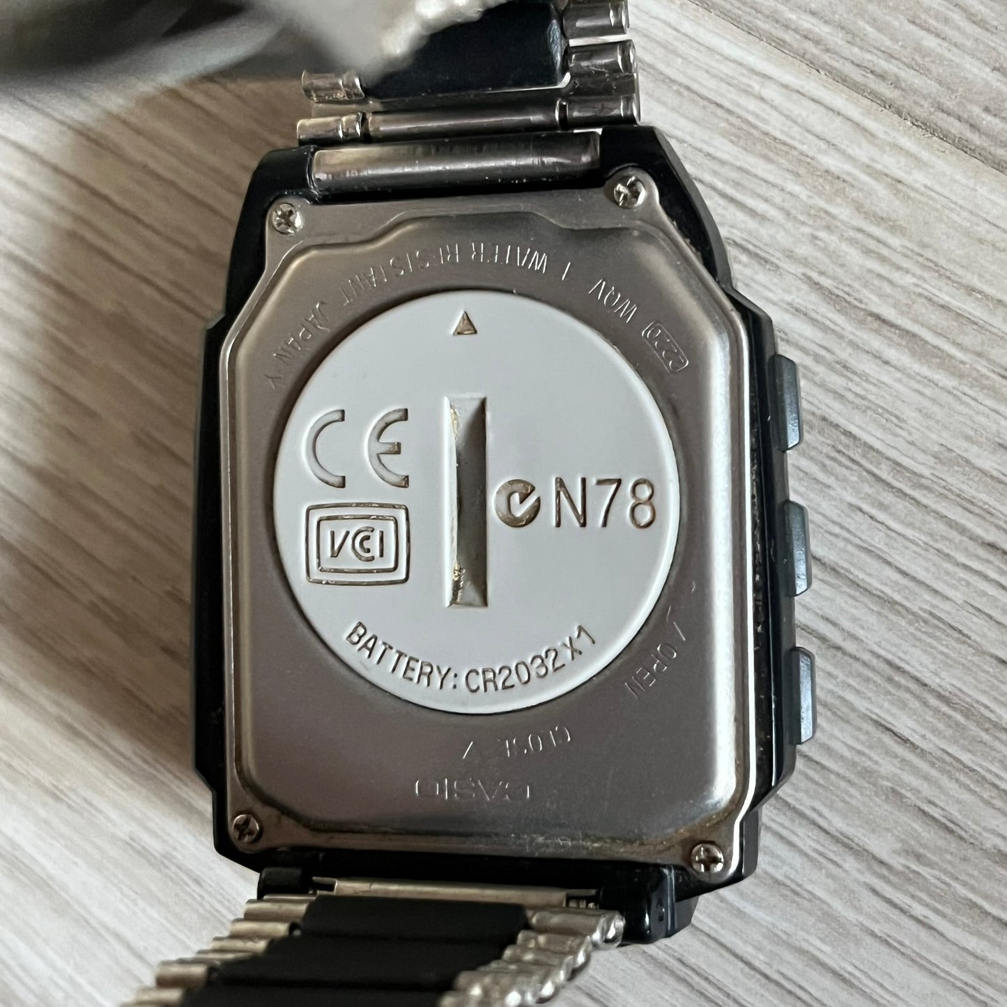 Casio Wrist Camera 2220 WQV-1 Digital Watch from the 2000s, made in Japan. Features a built-in camera module at the top, with six function buttons for photo capture, IR communication, alarm, timer, stopwatch, and gallery viewing. Monochrome photo output in shades of black, white, and gray; fitted with a non-original bracelet.