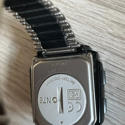 Casio Wrist Camera 2220 WQV-1 Digital Watch from the 2000s, made in Japan. Features a built-in camera module at the top, with six function buttons for photo capture, IR communication, alarm, timer, stopwatch, and gallery viewing. Monochrome photo output in shades of black, white, and gray; fitted with a non-original bracelet.