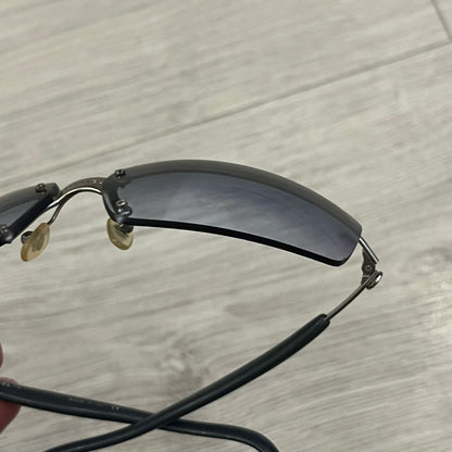 Chanel 4008 Rimless Silver Sunglasses with blue gradient lenses, combining a futuristic rimless design with vintage early 2000s style. Features CC logos on the temples, Chanel engraving on the bridge, and a silver metal frame. Made in Italy with CE certification.
