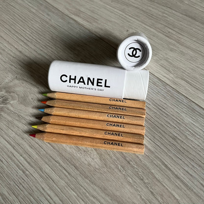 Chanel Mother’s Day Colored Pencils Set from 2021, presented in a white cylindrical tube with “Happy Mother’s Day” text and the Chanel logo on top. A Chanel Beauté complimentary gift featuring six branded colored pencils in blue, red, yellow, brown, orange, and green.
