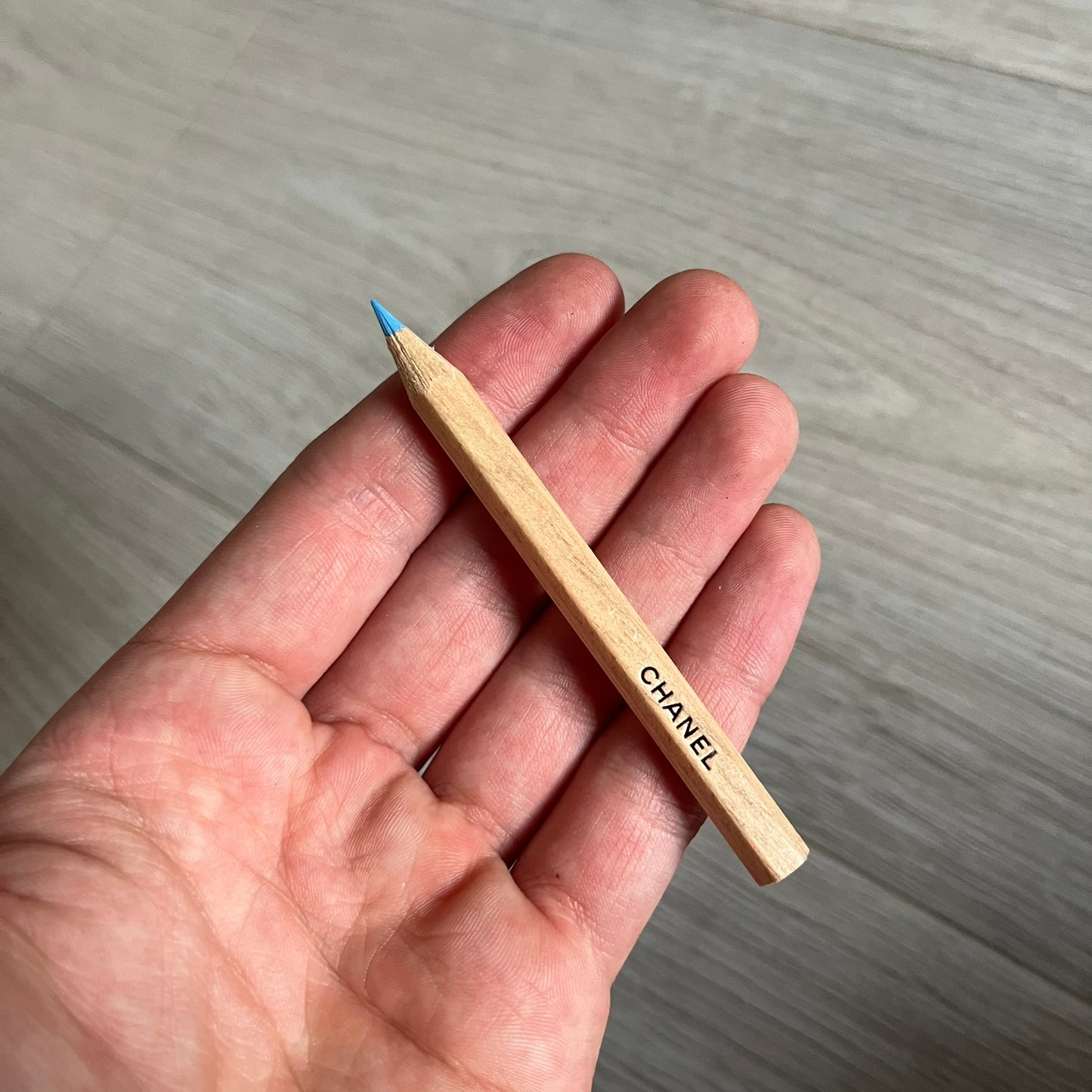 Chanel Mother’s Day Colored Pencils Set from 2021, presented in a white cylindrical tube with “Happy Mother’s Day” text and the Chanel logo on top. A Chanel Beauté complimentary gift featuring six branded colored pencils in blue, red, yellow, brown, orange, and green.