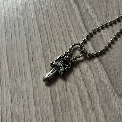 Chrome Hearts Dagger Zipper Pendant crafted from .925 silver, featuring the brand’s signature double-sided dagger design with “Chrome” on the guard and “Hearts” on the blade. Comes on a standard steel ball chain (non-CH). Circular bail for chain attachment. The dagger was originally a zipper pull.