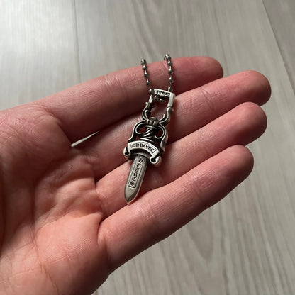 Chrome Hearts Dagger #10 Pendant crafted from genuine .925 silver, featuring the brand’s signature double-sided dagger design with “Chrome” on the guard and “Hearts” on the blade. Comes on a standard steel ball chain (non-CH). The top rectangular bail includes engraved markings: “89/03” on one side and “Sterling” on the other.