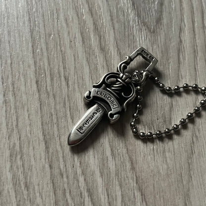 Chrome Hearts Dagger #10 Pendant crafted from genuine .925 silver, featuring the brand’s signature double-sided dagger design with “Chrome” on the guard and “Hearts” on the blade. Comes on a standard steel ball chain (non-CH). The top rectangular bail includes engraved markings: “89/03” on one side and “Sterling” on the other.