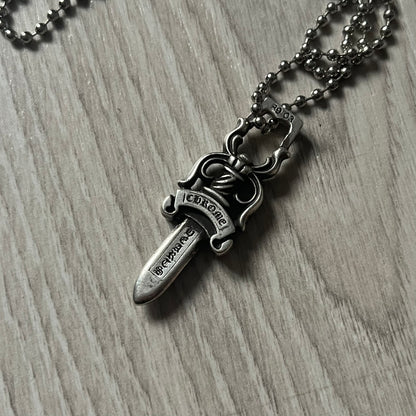 Chrome Hearts Dagger #10 Pendant crafted from genuine .925 silver, featuring the brand’s signature double-sided dagger design with “Chrome” on the guard and “Hearts” on the blade. Comes on a standard steel ball chain (non-CH). The top rectangular bail includes engraved markings: “89/03” on one side and “Sterling” on the other.&nbsp;