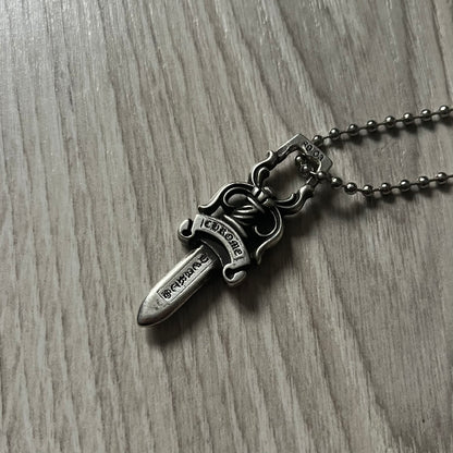 Chrome Hearts Dagger #10 Pendant crafted from genuine .925 silver, featuring the brand’s signature double-sided dagger design with “Chrome” on the guard and “Hearts” on the blade. Comes on a standard steel ball chain (non-CH). The top rectangular bail includes engraved markings: “89/03” on one side and “Sterling” on the other.&nbsp;