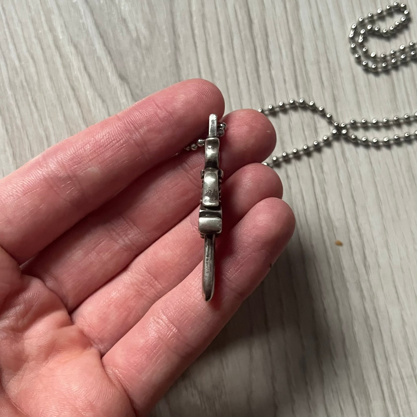 Chrome Hearts Dagger #10 Pendant crafted from genuine .925 silver, featuring the brand’s signature double-sided dagger design with “Chrome” on the guard and “Hearts” on the blade. Comes on a standard steel ball chain (non-CH). The top rectangular bail includes engraved markings: “89/03” on one side and “Sterling” on the other.&nbsp;