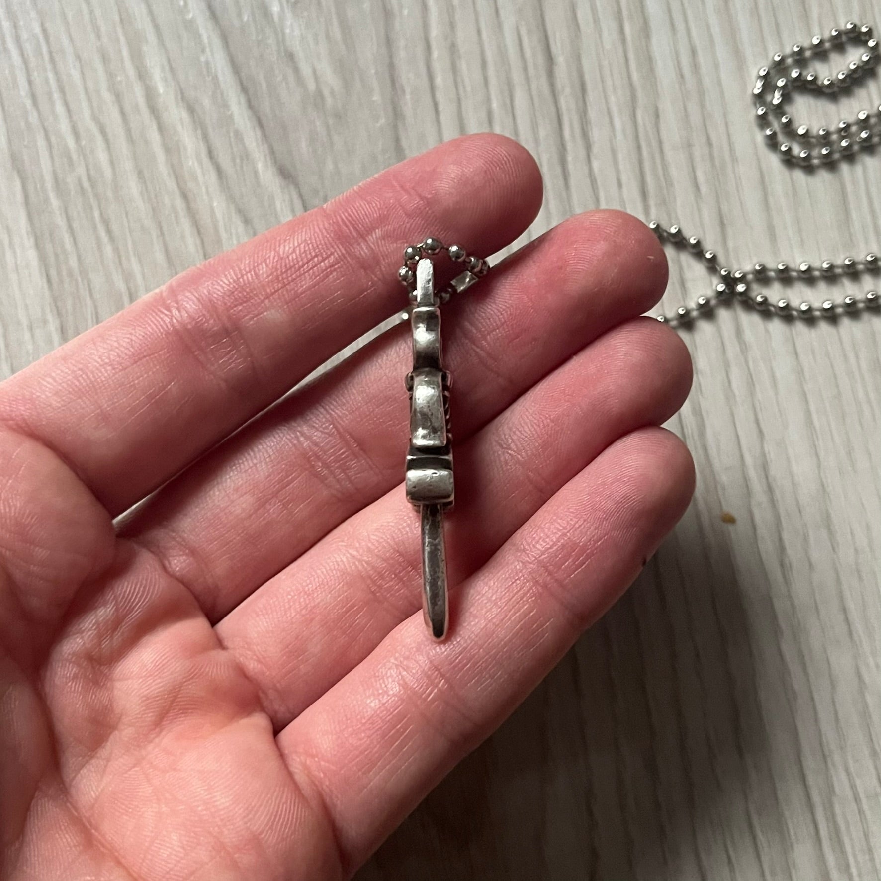 Chrome Hearts Dagger #10 Pendant crafted from genuine .925 silver, featuring the brand’s signature double-sided dagger design with “Chrome” on the guard and “Hearts” on the blade. Comes on a standard steel ball chain (non-CH). The top rectangular bail includes engraved markings: “89/03” on one side and “Sterling” on the other.&nbsp;