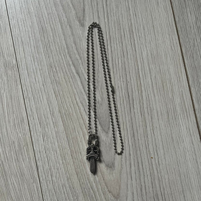 Chrome Hearts Dagger #10 Pendant crafted from genuine .925 silver, featuring the brand’s signature double-sided dagger design with “Chrome” on the guard and “Hearts” on the blade. Comes on a standard steel ball chain (non-CH). The top rectangular bail includes engraved markings: “89/03” on one side and “Sterling” on the other.&nbsp;