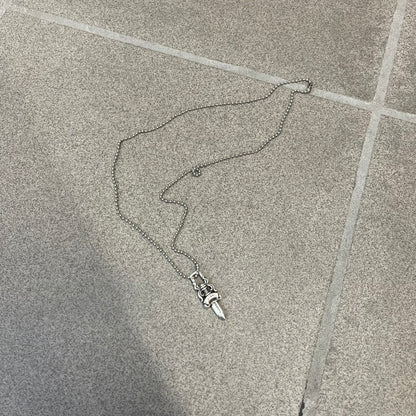 Chrome Hearts #5 Keychain Dagger Necklace crafted from .925 silver, featuring the brand’s signature double-sided dagger design with “Chrome” on the guard and “Hearts” on the blade. Comes on a stainless steel ball chain (non-CH). Square bail for chain attachment, the dagger was originally a keychain.