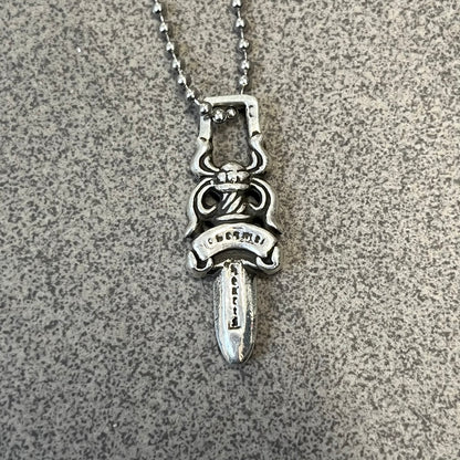 Chrome Hearts #5 Keychain Dagger Necklace crafted from .925 silver, featuring the brand’s signature double-sided dagger design with “Chrome” on the guard and “Hearts” on the blade. Comes on a stainless steel ball chain (non-CH). Square bail for chain attachment, the dagger was originally a keychain.