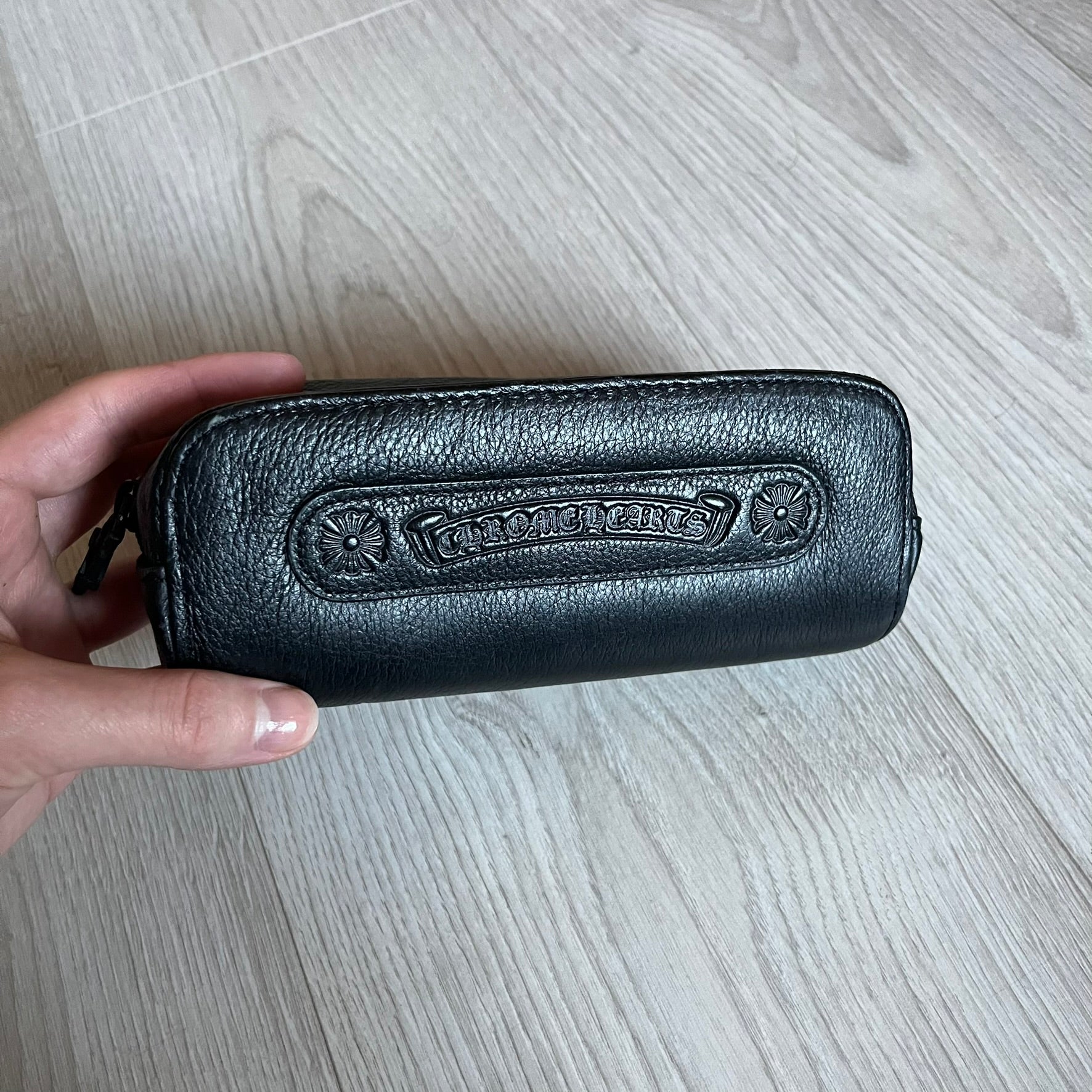 Chrome Hearts Stains Gold Sunglasses featuring a gold-tone metal frame with brown mirror-coated plastic lenses. Made in Japan, this model includes aged silver Chrome Hearts cross detailing wrapped around the arms, cut-out cross accents at the arm tips, and visible Chrome Hearts branding on the bridge and top of the frame. Additional cross branding appears on the nose pads. Comes complete with the original black leather Chrome Hearts zip case, finished with exterior branding and a dagger-shaped zipper pull.