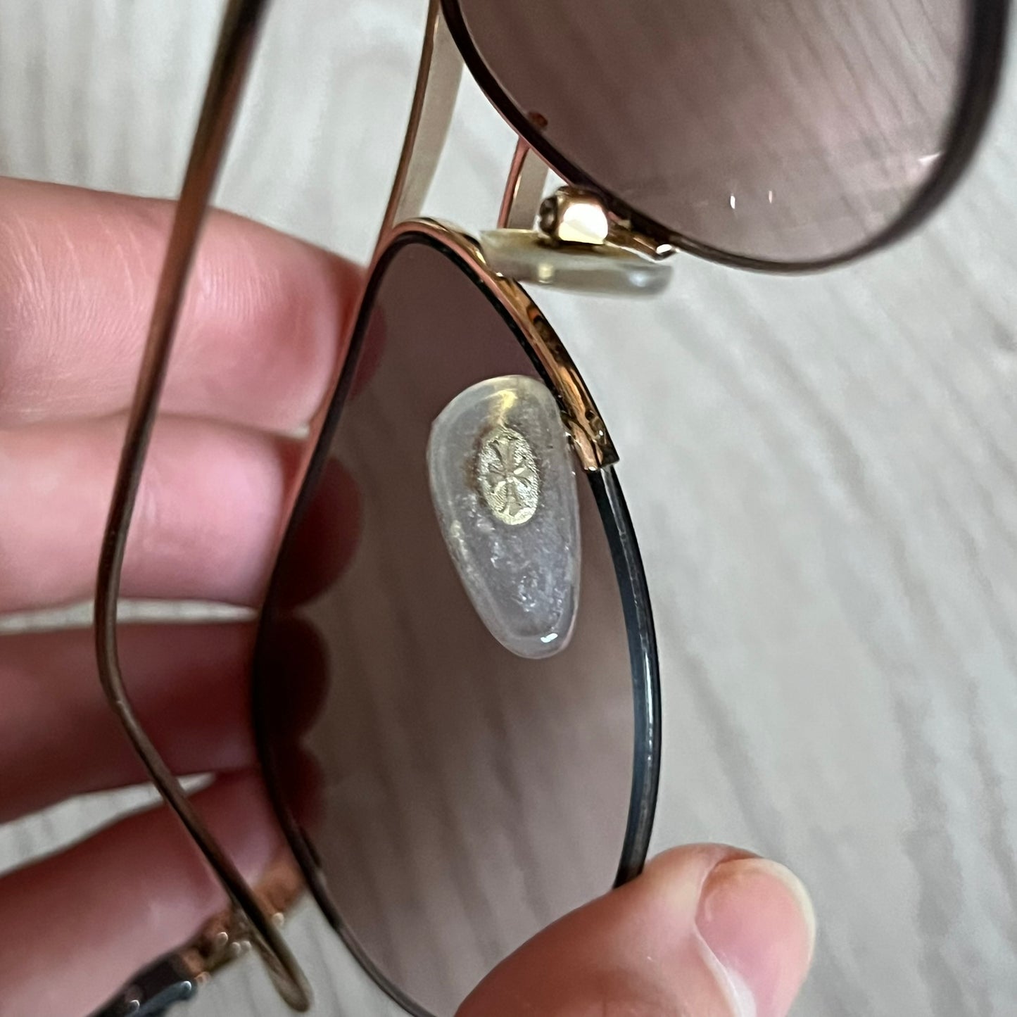 Chrome Hearts Stains Gold Sunglasses featuring a gold-tone metal frame with brown mirror-coated plastic lenses. Made in Japan, this model includes aged silver Chrome Hearts cross detailing wrapped around the arms, cut-out cross accents at the arm tips, and visible Chrome Hearts branding on the bridge and top of the frame. Additional cross branding appears on the nose pads. Comes complete with the original black leather Chrome Hearts zip case, finished with exterior branding and a dagger-shaped zipper pull.