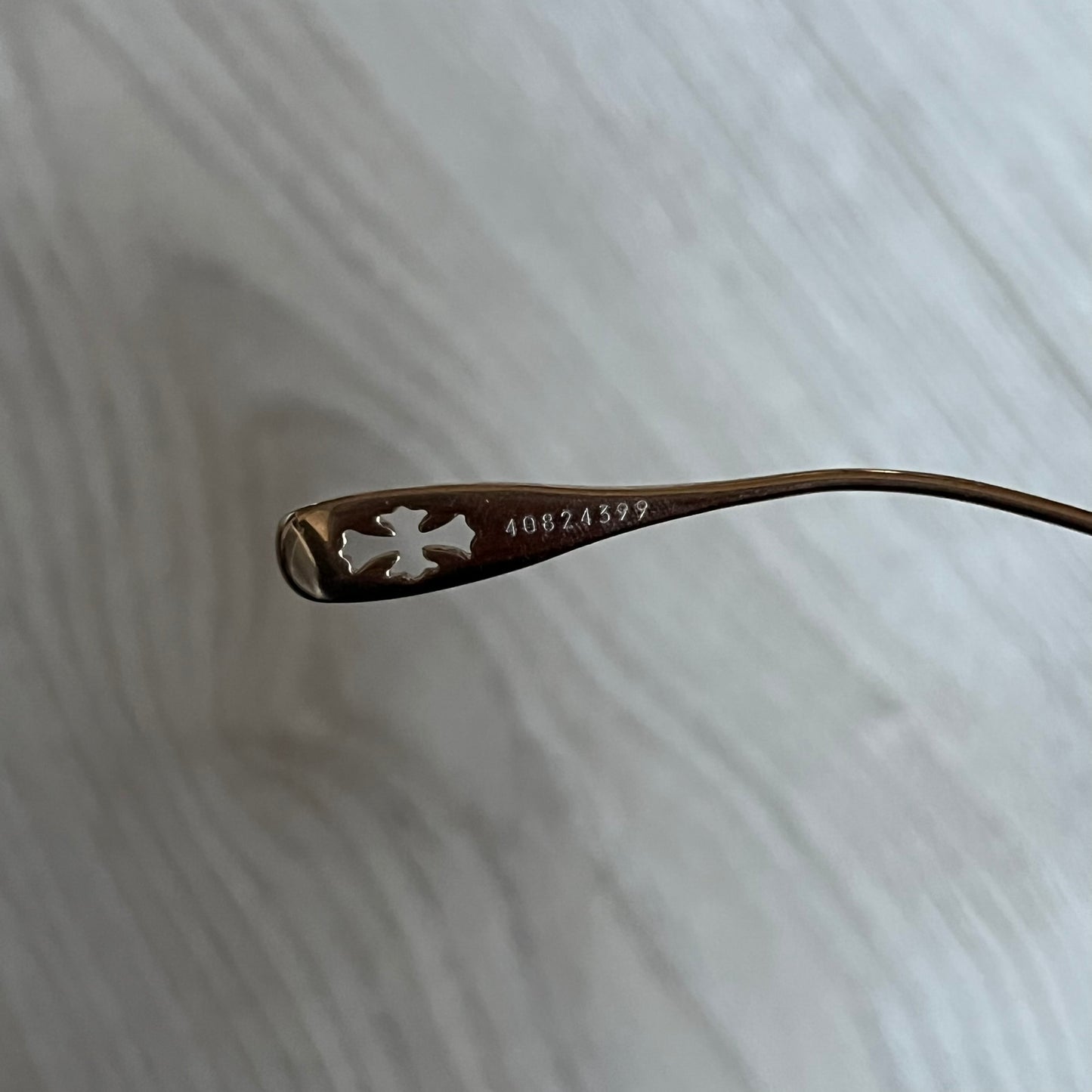 Chrome Hearts Stains Gold Sunglasses featuring a gold-tone metal frame with brown mirror-coated plastic lenses. Made in Japan, this model includes aged silver Chrome Hearts cross detailing wrapped around the arms, cut-out cross accents at the arm tips, and visible Chrome Hearts branding on the bridge and top of the frame. Additional cross branding appears on the nose pads. Comes complete with the original black leather Chrome Hearts zip case, finished with exterior branding and a dagger-shaped zipper pull.