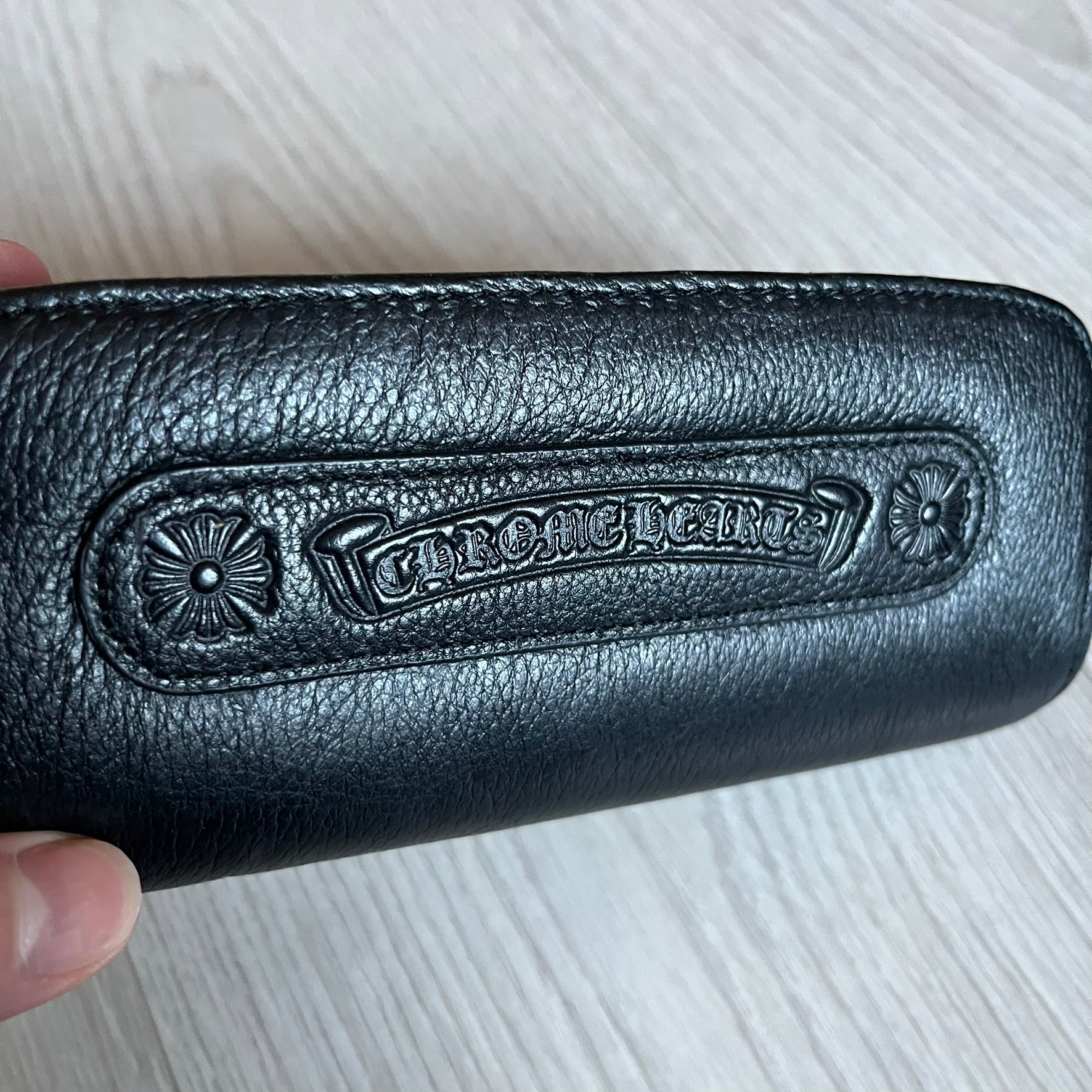 Chrome Hearts Stains Gold Sunglasses featuring a gold-tone metal frame with brown mirror-coated plastic lenses. Made in Japan, this model includes aged silver Chrome Hearts cross detailing wrapped around the arms, cut-out cross accents at the arm tips, and visible Chrome Hearts branding on the bridge and top of the frame. Additional cross branding appears on the nose pads. Comes complete with the original black leather Chrome Hearts zip case, finished with exterior branding and a dagger-shaped zipper pull.