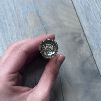 Chrome Hearts +22+ Roll-On Perfume features an aromatic oil blend with prominent jasmine and bergamot notes, designed as a concentrated roll-on fragrance. It is housed in a crystal bottle with a rhodium-plated sterling silver closure, hand crafted in France. The silver cap is detailed with raised Chrome Hearts crosses throughout, a larger cross on top, and embossed Chrome Hearts text wrapping around the base of the closure.