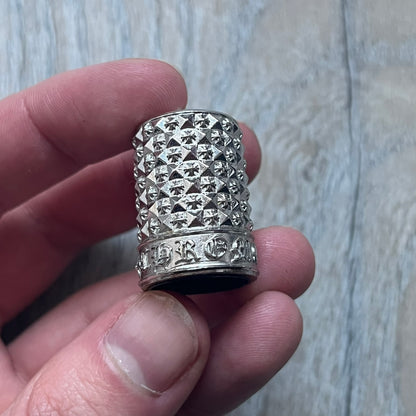 Chrome Hearts +22+ Roll-On Perfume features an aromatic oil blend with prominent jasmine and bergamot notes, designed as a concentrated roll-on fragrance. It is housed in a crystal bottle with a rhodium-plated sterling silver closure, hand crafted in France. The silver cap is detailed with raised Chrome Hearts crosses throughout, a larger cross on top, and embossed Chrome Hearts text wrapping around the base of the closure.