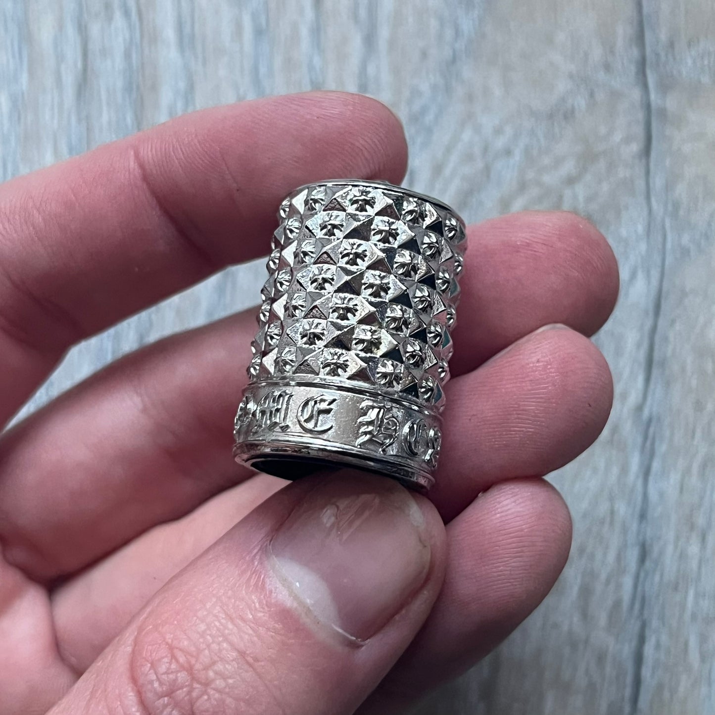 Chrome Hearts +22+ Roll-On Perfume features an aromatic oil blend with prominent jasmine and bergamot notes, designed as a concentrated roll-on fragrance. It is housed in a crystal bottle with a rhodium-plated sterling silver closure, hand crafted in France. The silver cap is detailed with raised Chrome Hearts crosses throughout, a larger cross on top, and embossed Chrome Hearts text wrapping around the base of the closure.