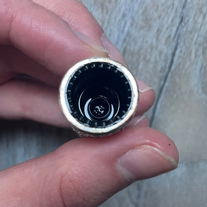 Chrome Hearts +22+ Roll-On Perfume features an aromatic oil blend with prominent jasmine and bergamot notes, designed as a concentrated roll-on fragrance. It is housed in a crystal bottle with a rhodium-plated sterling silver closure, hand crafted in France. The silver cap is detailed with raised Chrome Hearts crosses throughout, a larger cross on top, and embossed Chrome Hearts text wrapping around the base of the closure.