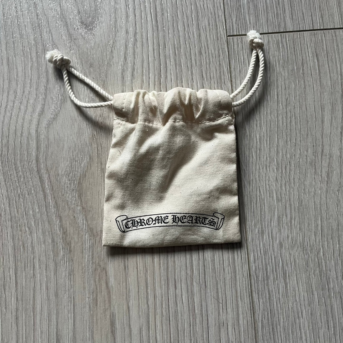 The Chrome Hearts 'Silichrome' Cross Purple Necklace showcases a silicone cross pendant with embossed CH lettering, twin cross graphics on the back, and a 2019 anniversary mark. Offered only through CH flagship stores, it comes paired with a purple ball chain and includes both the dustbag and paper receipt.