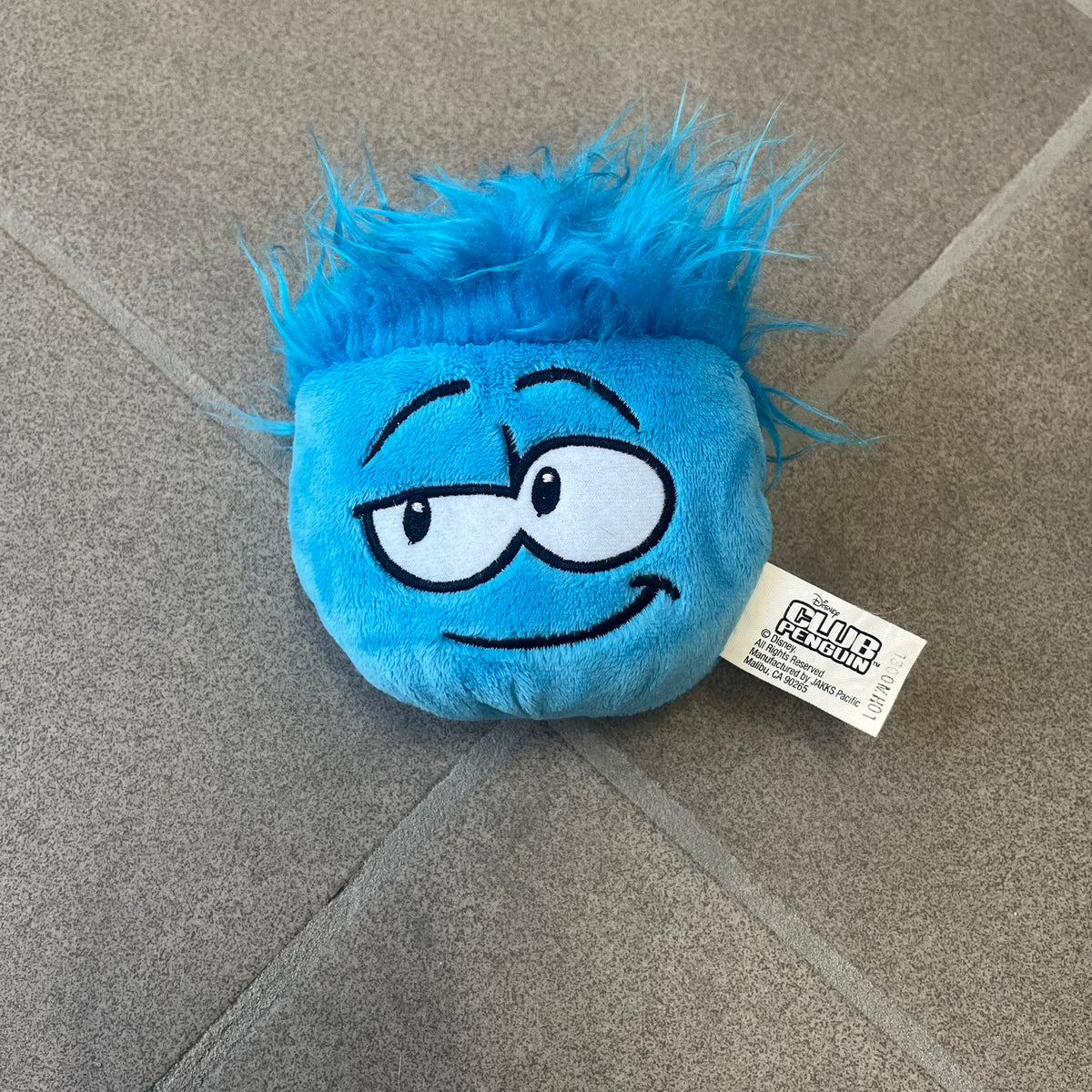 Club Penguin Series 2 Blue Puffle Plushie was Released in 2009 by Disney and Jakks Pacific, featuring a smirking embroidered face, troll-like hair and a half plush half beanie body. It comes with a Disney-licensed tag.