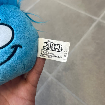 Club Penguin Series 2 Blue Puffle Plushie was Released in 2009 by Disney and Jakks Pacific, featuring a smirking embroidered face, troll-like hair and a half plush half beanie body. It comes with a Disney-licensed tag.