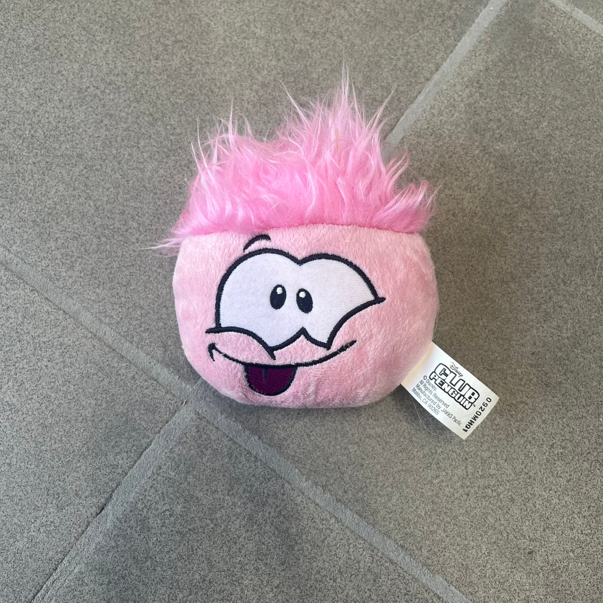 Club Penguin Series 2 Pink Puffle Plushie was Released in 2009 by Disney and Jakks Pacific, featuring an embroidered happy face with a tongue out, troll-like hair and a half plush half beanie body. It comes with a Disney-licensed tag.