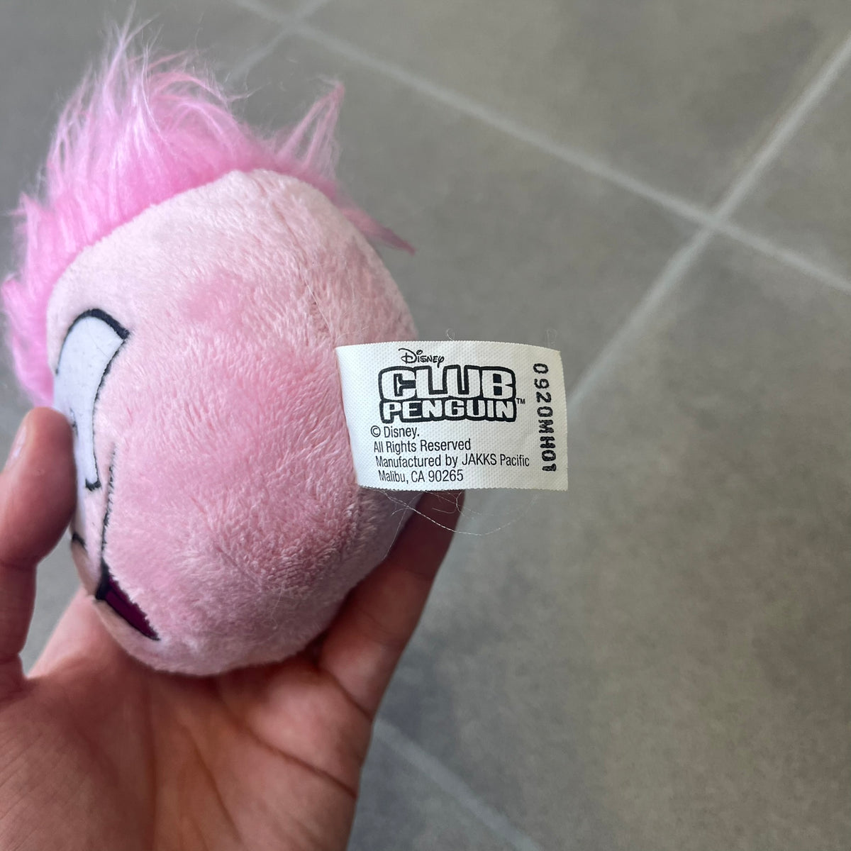 Club Penguin Series 2 Pink Puffle Plushie was Released in 2009 by Disney and Jakks Pacific, featuring an embroidered happy face with a tongue out, troll-like hair and a half plush half beanie body. It comes with a Disney-licensed tag.
