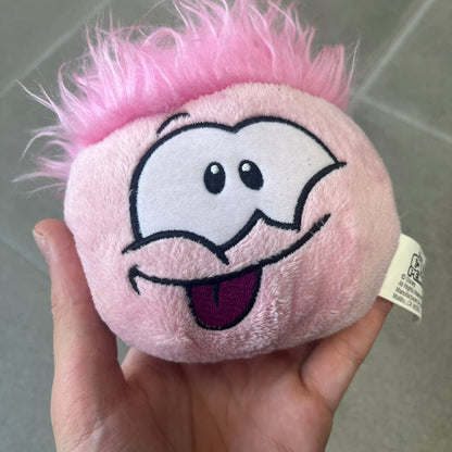 Club Penguin Series 2 Pink Puffle Plushie was Released in 2009 by Disney and Jakks Pacific, featuring an embroidered happy face with a tongue out, troll-like hair and a half plush half beanie body. It comes with a Disney-licensed tag.