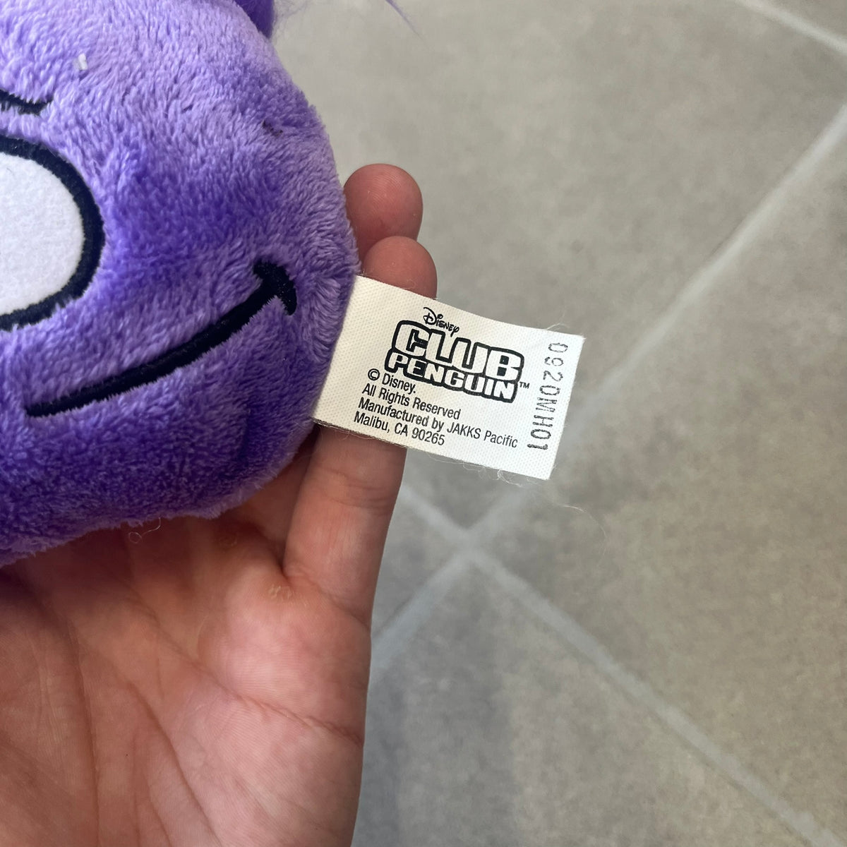 Club Penguin Series 2 Purple Puffle Plushie was Released in 2009 by Disney and Jakks Pacific, featuring a smirking looking up embroidered face, troll-like hair and a half plush half beanie body. It comes with a Disney-licensed tag.
