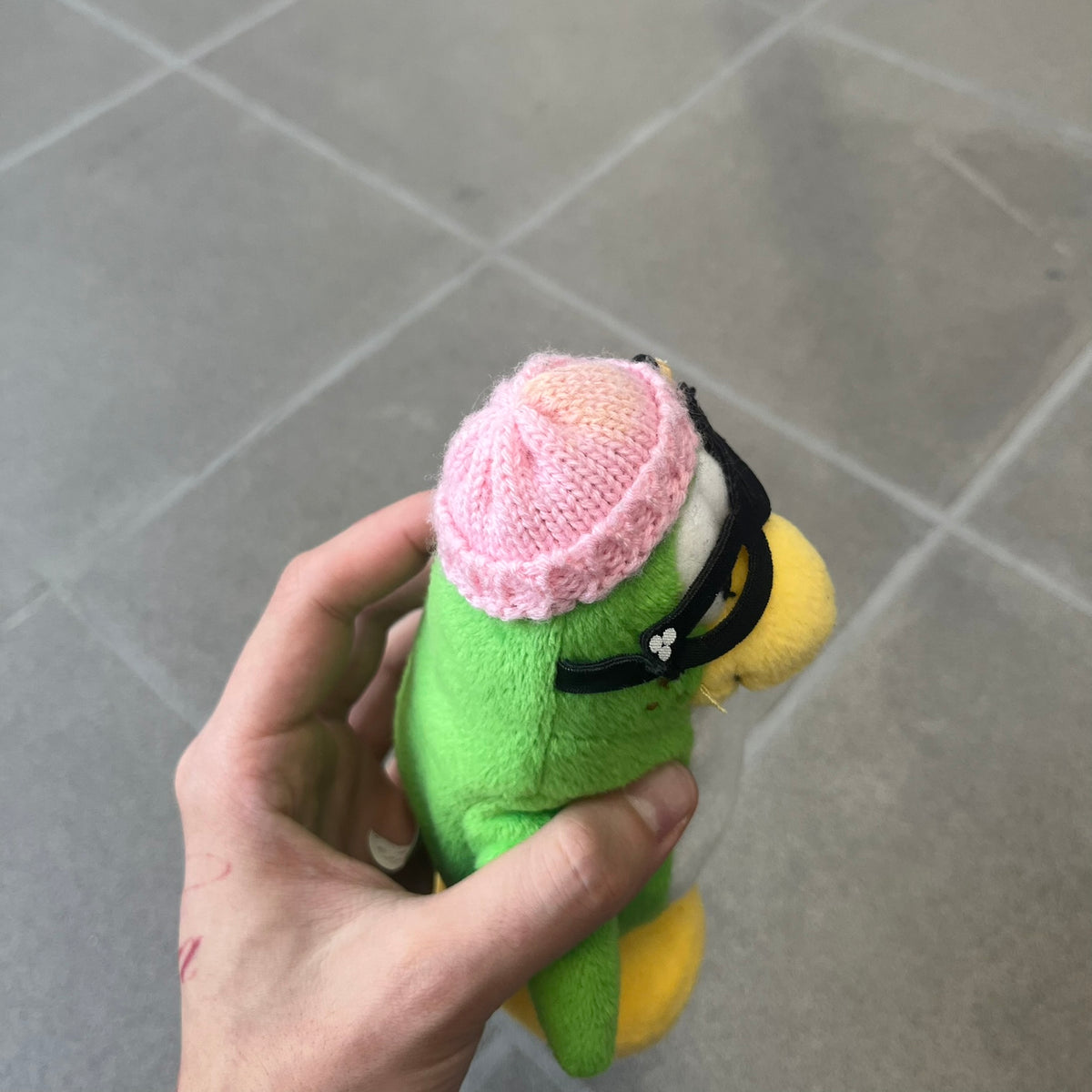 Club Penguin 2009 Series 3 Aunt Arctic Penguin Plushie is a green penguin with a pink beanie, freckles, black eyeglasses and a pencil next to the ear. Released in [year] by Disney and Jakks Pacific, featuring an embroidered Club Penguin logo on the bottom of the foot. It comes with a Disney-licensed tag.