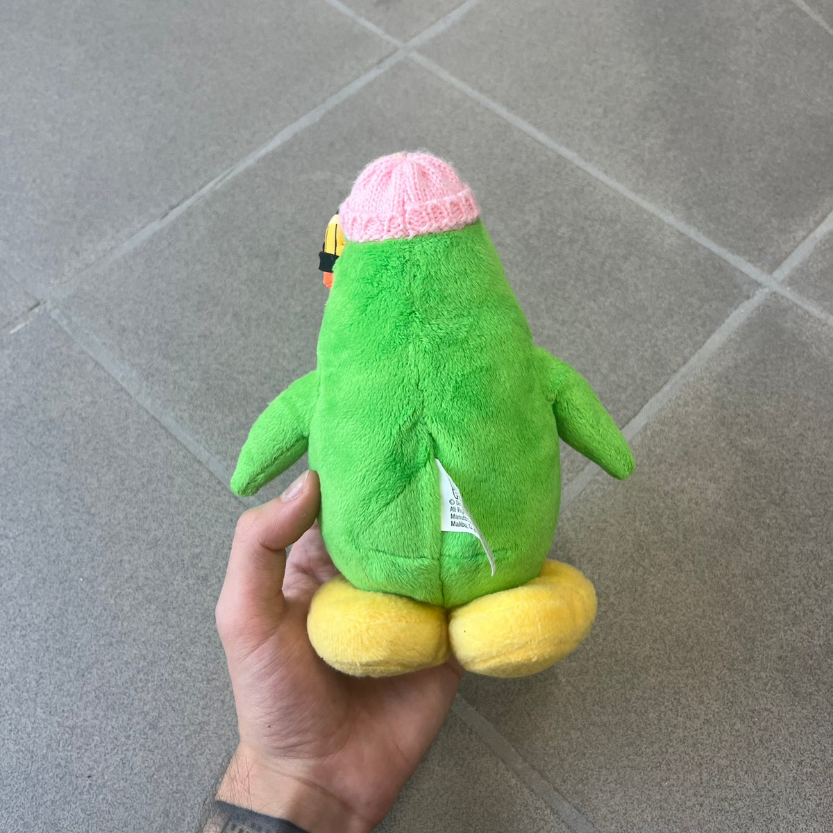 Club Penguin 2009 Series 3 Aunt Arctic Penguin Plushie is a green penguin with a pink beanie, freckles, black eyeglasses and a pencil next to the ear. Released in [year] by Disney and Jakks Pacific, featuring an embroidered Club Penguin logo on the bottom of the foot. It comes with a Disney-licensed tag.