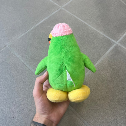 Club Penguin 2009 Series 3 Aunt Arctic Penguin Plushie is a green penguin with a pink beanie, freckles, black eyeglasses and a pencil next to the ear. Released in [year] by Disney and Jakks Pacific, featuring an embroidered Club Penguin logo on the bottom of the foot. It comes with a Disney-licensed tag.
