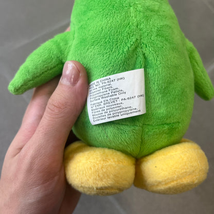 Club Penguin 2009 Series 3 Aunt Arctic Penguin Plushie is a green penguin with a pink beanie, freckles, black eyeglasses and a pencil next to the ear. Released in [year] by Disney and Jakks Pacific, featuring an embroidered Club Penguin logo on the bottom of the foot. It comes with a Disney-licensed tag.
