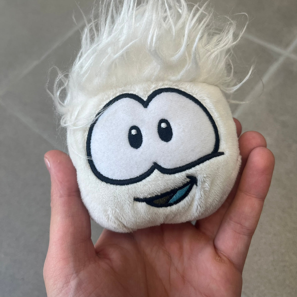 Club Penguin Series 3 White Puffle Plushie was Released in 2009 by Disney and Jakks Pacific, featuring a happy embroidered face, troll-like hair and a half plush half beanie body. It comes with a Disney-licensed tag.